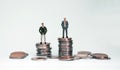 Coins and miniature people and business concept. Royalty Free Stock Photo